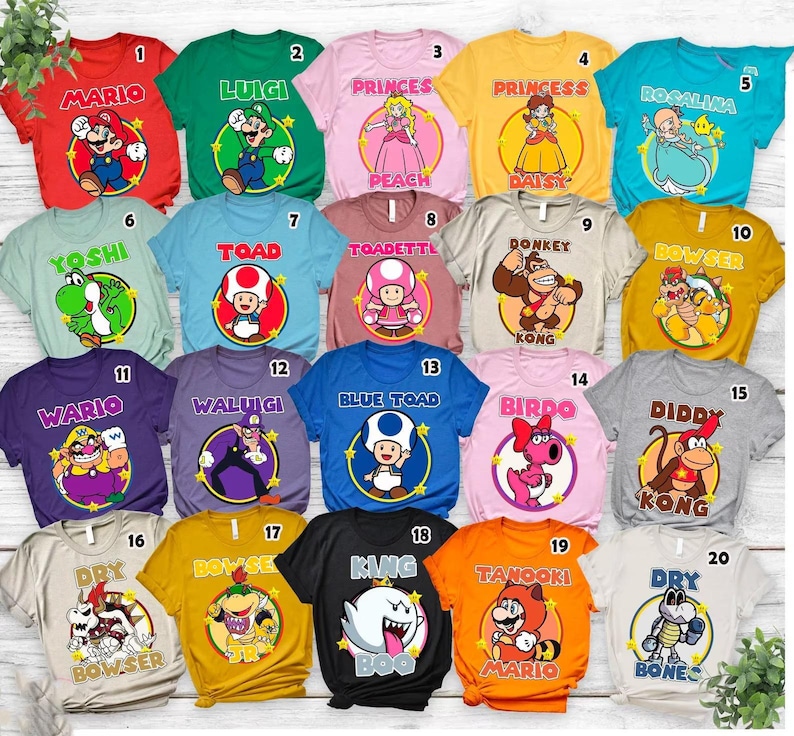 May include: A collection of twenty short-sleeved t-shirts in various colors, each featuring a unique Nintendo character graphic inside a circular frame with a name printed above, numbered one through twenty in a grid layout.