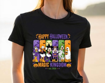 May include: A black short-sleeve t-shirt featuring a graphic of Disney characters in Halloween costumes. The text reads Happy Halloween Magic Kingdom est. 2026. The design includes Mickey, Minnie, Donald, Daisy, Goofy, and Pluto with pumpkins.