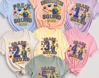 May include: A collection of seven short-sleeved t-shirts in various pastel colors, each featuring a graphic of a block-style character in a varsity jacket, school supplies, and text ranging from Pre-K Squad 2026 to Grade 5 Squad 2026.