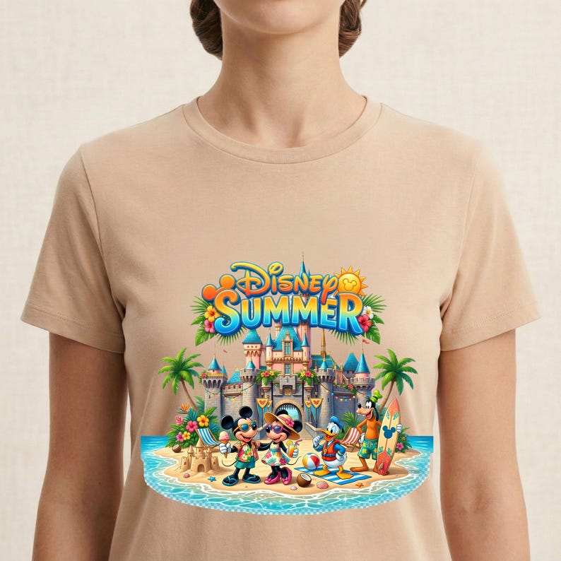 May include: A beige t-shirt featuring a colorful graphic of Disney characters including Mickey, Minnie, Donald, and Goofy at a beach in front of a castle. The text Disney Summer is printed in blue and orange above the castle with palm trees and flowers.