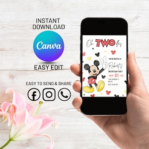 May include: A smartphone displays a birthday party invitation featuring Mickey Mouse. The invitation reads "Oh TWO-dles" and includes the text "You're invited to Robert's 2nd Birthday Party". The phone is held in a hand, with additional text and social media icons visible.