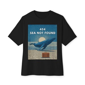 May include: Black t-shirt with a graphic featuring a blue whale leaping from the ocean, a suitcase, and the text "404 SEA NOT FOUND." The design has a vintage, distressed look.