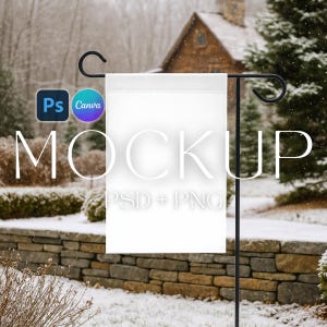 May include: A white garden flag mockup displayed on a black metal stand. The flag is blank, with the word "MOCKUP" in a large, stylized font. The background shows a snowy outdoor scene with a stone wall and evergreen trees.