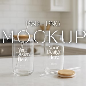 May include: Two clear glass beverage cups with bamboo lids and straws. The cups have the text "Your Design Here" printed on them. The image also includes the text "PSD + PNG" and "MOCKUP".