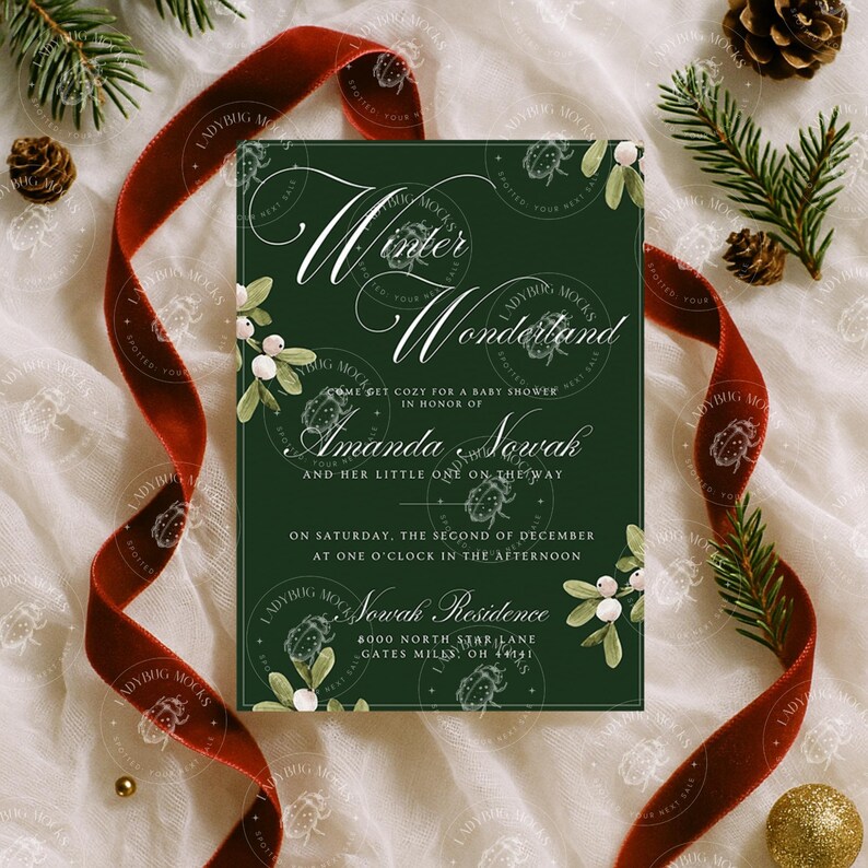 May include: A dark green baby shower invitation with the words "Winter Wonderland" in elegant script. The invitation includes the name "Amanda Nowak" and event details. A red velvet ribbon, pine needles, and gold accents surround the invitation.