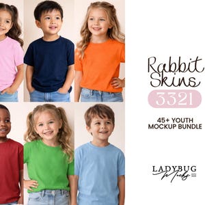 May include: A mockup bundle featuring six children wearing solid-color t-shirts in various colors: pink, navy blue, orange, red, green, and light blue. The image includes the text "Rabbit Skins 3321" and "45+ Youth Mockup Bundle."