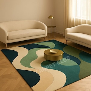 May include: A modern area rug with a wavy design in shades of green, beige, and navy blue. The rug is in a living room setting with a gold coffee table and two cream-colored sofas. The text "CARPET CLUB" is visible on the rug.
