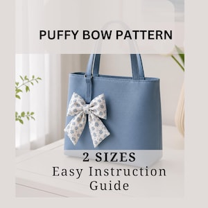 May include: A pale blue handbag with a decorative puffy bow. The bow features a white fabric with a blue floral design. Text on the image reads: "PUFFY BOW PATTERN", "2 SIZES", and "Easy Instruction Guide".