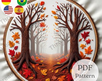May include: An embroidery hoop featuring a fall forest scene. Two large trees frame a path leading into the distance, with colorful leaves scattered on the ground. The design includes the text "PDF Pattern" and the Etsy shop name.