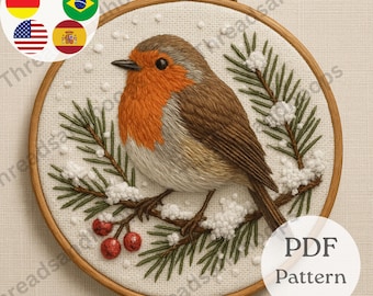 May include: Embroidered robin bird in a wooden hoop. The bird has an orange breast, brown wings, and is perched on a branch with green pine needles and red berries. The embroidery is on a white fabric. The text "PDF Pattern" is visible.