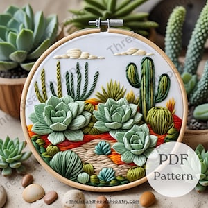 May include: A detailed embroidery hoop art piece featuring a desert landscape with cacti and succulents in shades of green, orange, and brown. The design includes a variety of textures and is set against a white background. The text "PDF Pattern" is visible.