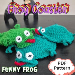 May include: Three handmade crochet frog coasters in shades of green and teal. Each coaster features white eyes with black cross details, a red mouth, and small legs. The image includes the text "Frog Coaster" and "Funny Frog".