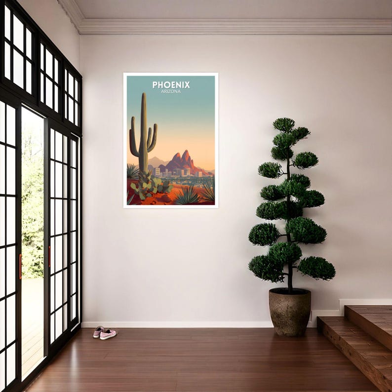 May include: A framed art print featuring a desert landscape with a large cactus, mountains, and the text "PHOENIX ARIZONA" in white. The artwork has a color palette of orange, green, and blue.