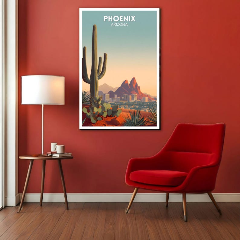 May include: A framed art print featuring a desert landscape with a large saguaro cactus, mountains, and a city skyline. The print has the text "PHOENIX ARIZONA" at the top, with a color palette of orange, green, and blue.