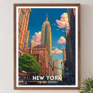 May include: A framed print of New York City featuring the Empire State Building. The artwork showcases a vibrant cityscape with a yellow bus, buildings, and the text "NEW YORK UNITED STATES". The sky is blue with fluffy clouds.