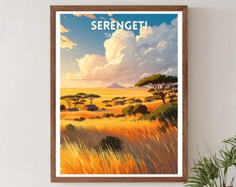 May include: A framed art print of the Serengeti in Tanzania. The landscape features golden grasses, scattered trees, and a distant mountain under a blue sky with large, fluffy clouds. The print is in a wooden frame.