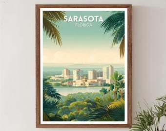 May include: A framed art print featuring a scenic view of Sarasota, Florida. The artwork showcases a cityscape with buildings, a body of water, and lush green foliage, including palm fronds. The text "SARASOTA FLORIDA" is at the top.