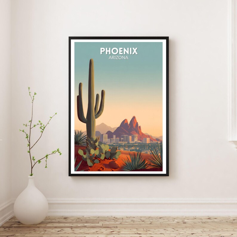 May include: A framed art print featuring a desert landscape with a large saguaro cactus, mountains, and the city of Phoenix, Arizona. The print has a black frame and the text "PHOENIX ARIZONA" at the top.
