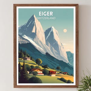 Puede incluir: Una impresión enmarcada que presenta un paisaje estilizado de la montaña Eiger en Suiza. La obra de arte representa picos nevados, colinas verdes y pequeñas casas con tejados rojos bajo un cielo azul. El texto "EIGER SUIZA" está en la parte superior.