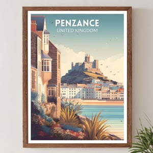 May include: A framed art print featuring a coastal scene of Penzance, United Kingdom. The artwork depicts a castle on a hill, buildings along the shore, and the text "Penzance United Kingdom" at the top. The print is in a wooden frame.