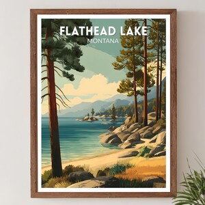 May include: A framed art print of Flathead Lake, Montana. The artwork depicts a serene lake scene with a sandy beach, rocky shoreline, and tall pine trees. The sky is a mix of blue and yellow, with mountains in the background.