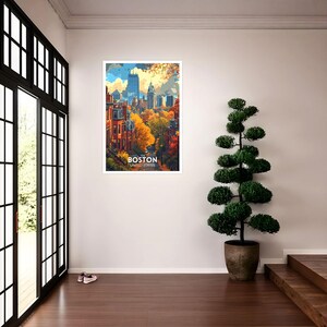 May include: A framed art print featuring a colorful illustration of Boston, Massachusetts. The artwork depicts a cityscape with autumn foliage and the text "BOSTON UNITED STATES" at the bottom. The print is displayed in a white frame.