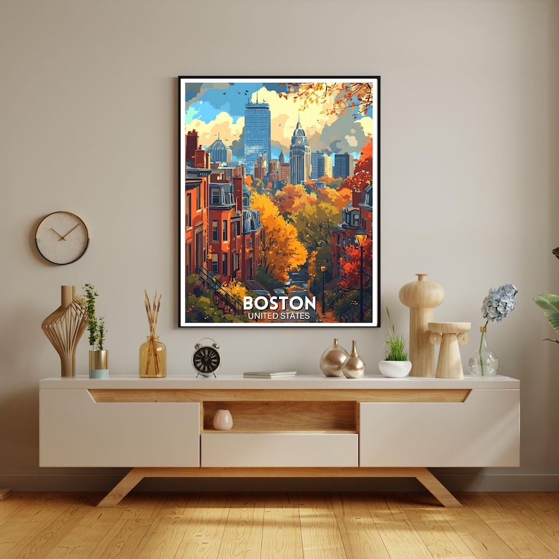 May include: A framed art print of Boston, United States, featuring a colorful cityscape with autumn foliage. The artwork showcases buildings, trees, and a blue sky with clouds. The print includes the word "Boston" and "United States".