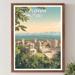 May include: A framed art print featuring a scenic view of Plovdiv, Bulgaria. The artwork depicts a cityscape with buildings, mountains, and a stadium, framed by lush greenery and the text "Plovdiv Bulgaria". The color palette includes greens, blues, and warm tones.