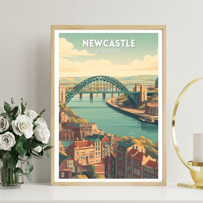 May include: A framed art print featuring a stylized illustration of Newcastle, England. The image showcases a teal-colored bridge spanning a river, with buildings along the banks. The text "NEWCASTLE ENGLAND" is at the top of the print. The artwork has a vintage travel poster aesthetic.