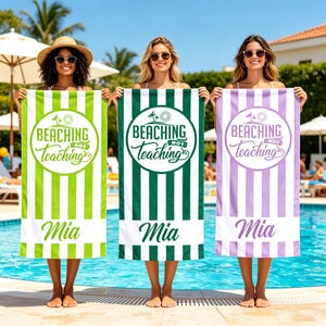 May include: Three beach towels with vertical stripes in green, dark green, and purple. Each towel has the text "BEACHING NOT TEACHING" in a circle, the name "Mia" at the bottom, and a beach theme.