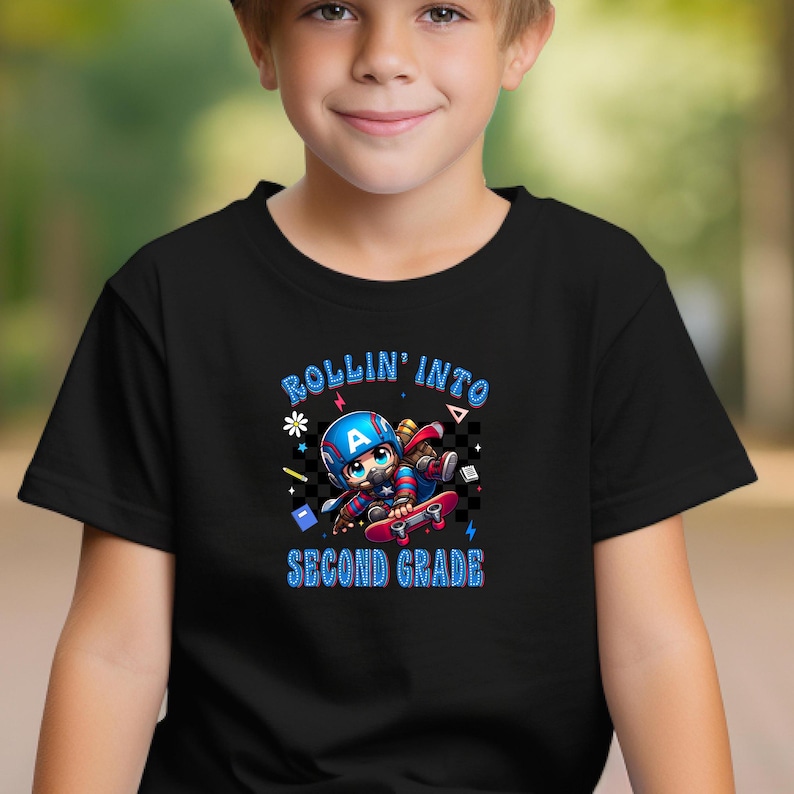 May include: Black t-shirt featuring a cartoon illustration of a character in a Captain America-style helmet riding a skateboard. The text "ROLLIN' INTO SECOND GRADE" is in blue and white.