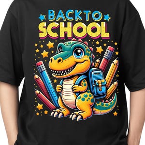May include: Black t-shirt featuring a colorful graphic of a cartoon dinosaur with a backpack, surrounded by pencils and stars. The text "BACK TO SCHOOL" is displayed above the dinosaur in yellow and blue.