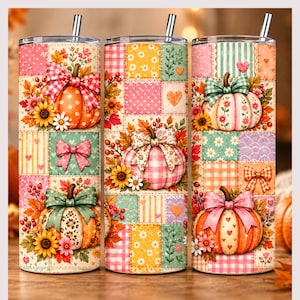 May include: Three cylindrical tumblers with lids and straws, featuring a patchwork design of autumn-themed patterns. The print includes orange, pink, and green pumpkins decorated with bows, sunflowers, berries, hearts, and plaid or polka dot motifs.