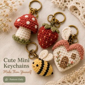 May include: Four crocheted keychains featuring a red and white mushroom, a red strawberry with green leaves, a yellow and black striped bee, and a heart-shaped house with a brown door. The text reads Cute Mini Keychains Make Them Yourself.
