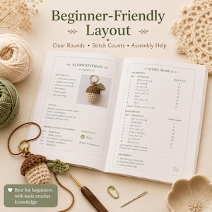 May include: An open crochet pattern book titled Beginner-Friendly Layout featuring instructions for an acorn keychain. The page displays materials, abbreviations, and step-by-step rounds for the brown cap and beige body, alongside a finished acorn keychain.