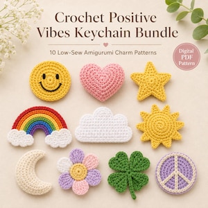 May include: A digital PDF pattern for a Crochet Positive Vibes Keychain Bundle featuring 10 low-sew amigurumi charm designs including a yellow smiley face, pink heart, yellow star, rainbow, white cloud, yellow sun, cream moon, flower, clover, and peace sign.