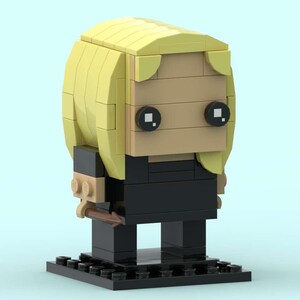 May include: A Lego-style figure with a blonde hairstyle, tan face, and black eyes. The figure wears a black outfit and stands on a black base. The overall design is blocky and geometric, with a light blue background.