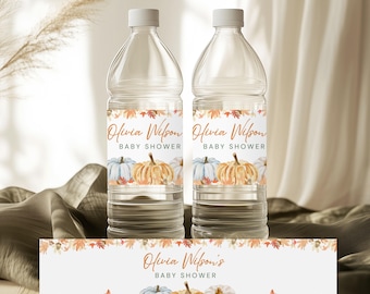 May include: Two clear water bottles with white caps, each featuring a label with the text "Olivia Wilson BABY SHOWER." The labels showcase watercolor pumpkins in shades of blue, orange, and white, surrounded by fall foliage. A matching banner is at the bottom.