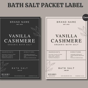 May include: Two bath salt packet labels. One is black with white text, the other is light pink with black text. Both feature the words "Vanilla Cashmere Organic Bath Salt". The labels include ingredients and directions.