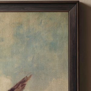 May include: A framed painting in a dark brown wooden frame. The artwork uses a soft, impressionistic style with a blend of blue, white, and brown hues. The brushstrokes create a textured effect, evoking a sense of depth and movement.