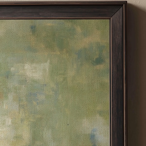 May include: Abstract landscape painting in a dark brown wooden frame. The artwork features a textured canvas with a palette of greens, blues, and hints of yellow. The brushstrokes create a sense of depth and movement, evoking a natural scene.
