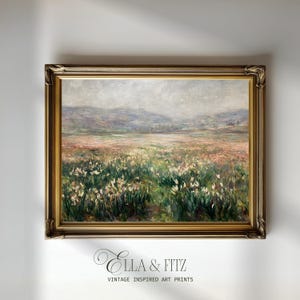 May include: A framed landscape painting with a field of white flowers in the foreground, mountains in the background, and a cloudy sky. The frame is gold-toned with ornate detailing. The text "Ella & Fitz" and "VINTAGE INSPIRED ART PRINTS" is at the bottom.