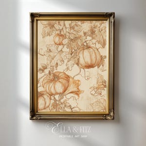 May include: A framed wall art print featuring a sepia-toned botanical illustration of pumpkins and sprawling vines on a cream background. The ornate dark gold frame surrounds the artwork, which includes the text ELLA & FITZ PRINTABLE ART SHOP.