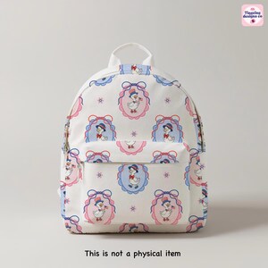 Pu&ograve; includere: Zaino bianco con un motivo ripetuto di un'anatra con cappello e bandiera, incorniciato in ovali rosa e blu. Lo zaino ha una tasca frontale e una maniglia superiore. Il testo "This is not a physical item" &egrave; in basso.
