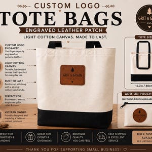 May include: A light cotton canvas tote bag with a black base and black handles, featuring a brown leather patch engraved with the Grit & Grain LLC logo. The bag measures 14.9 inches high and 15.7 inches wide. A matching small zippered pouch is included.