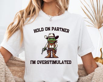 Hold On Partner I’m Overstimulated Shirt Cowboy Frog Meme Tee Anxiety