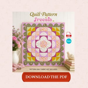 May include: A colorful quilt pattern titled "freesia" with a floral design in shades of pink, yellow, and green. The text "DOWNLOAD THE PDF" is on a red button. The pattern is displayed on a wooden surface.