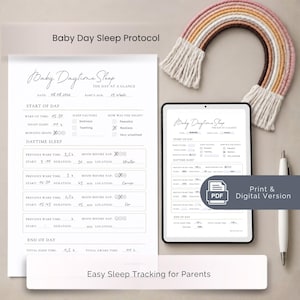 May include: A printed Baby Daytime Sleep tracking sheet and a tablet displaying the same digital document. The form includes sections for date, age, wake-up time, sleep factors, and nap logs. A white pen and a decorative yarn rainbow are present.