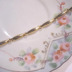 Linked gold tone bracelet