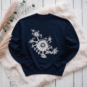 May include: A navy blue crewneck sweatshirt featuring a white graphic print on the chest. The design consists of a complex, repeating fractal pattern with a central circular motif surrounded by smaller, intricate, swirling geometric shapes.